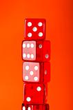 Red dice stack against orange background