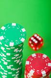 Casino chips and dice against green background