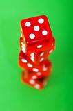 Red dice against green background - shallow DOF