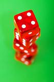 Red dice against green background - shallow DOF
