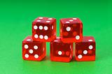 Red dice against green background