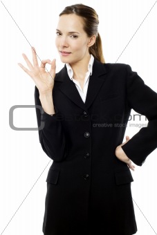 young businesswoman with her hand indicating ok on white background studio