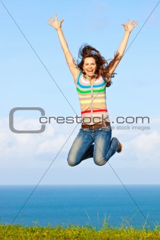 Beautiful young woman jumping up in the air smiling