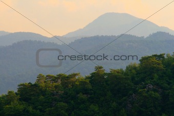 Wooded mountains in the haze