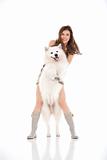 young woman and white dog standing up