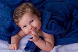 Beautiful baby under blue towel