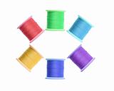 Few color thread bobbins isolated on white