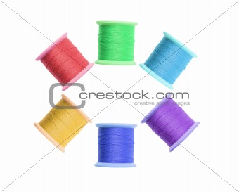 Few color thread bobbins isolated on white