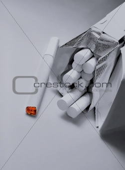Closeup of pack of cigarettes on grey background