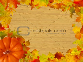 Fall leaves and pumpkins on wood background.