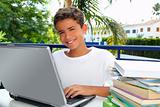 Happy teenager student boy working laptop