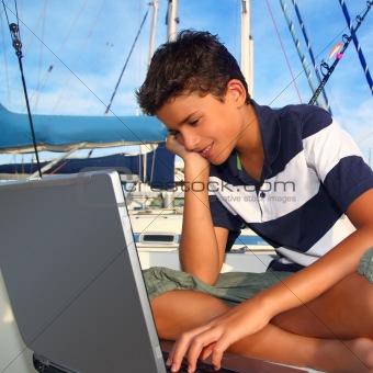  teenager on boat with laptop computer