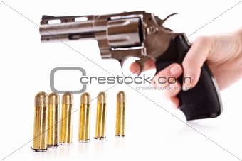 Bullets and revolver in hand. Not real gun (lighter)