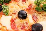 Pizza with olives closeup
