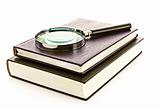 Hard cover book and magnifier isolated on white