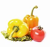 Two peppers and tomato on green salad isolated