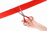 Red ribbon, scissors and hand isolated on white
