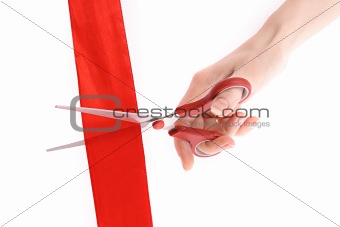 Red ribbon, scissors and hand isolated on white
