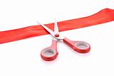 Red ribbon with scissors isolated on white
