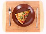 Pizza on plate with fork and knife