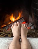 Children's feet are heated in the fireplace