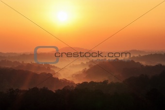 sun rise above a fog and mountain