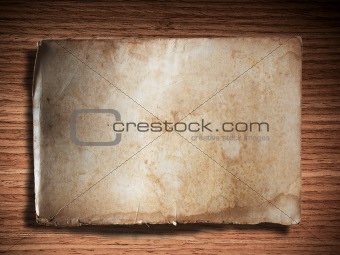 old grunge paper on oak wood