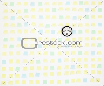 note papers and clock on office wall business