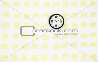 note papers and clock on office wall business