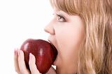 The girl bites an apple