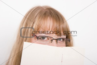 The girl hides behind the book