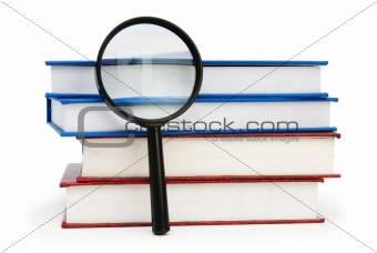 Magnifying glass over the stack of books