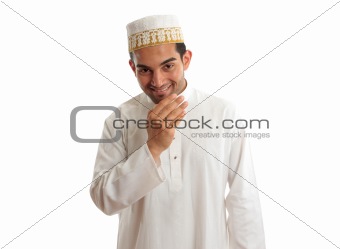 Smiling ethnic man in traditional robe and topi