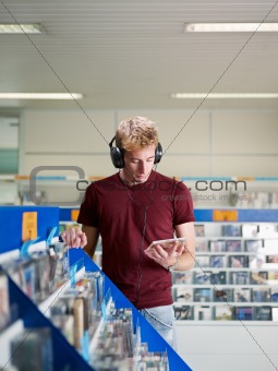 guy listening music in cd store