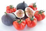 Figs and tomatoes for salad on white background