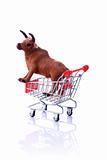 Model cow in shopping cart isolated on white