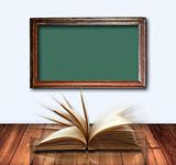 open book on wood table and old Green board