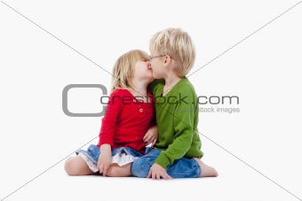 children - brother and sister kissing each other - isolated on white