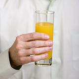 Glass with orange juice in a hand