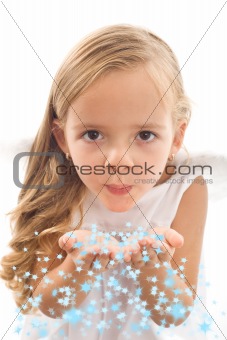 Little girl blowing stars from her palms