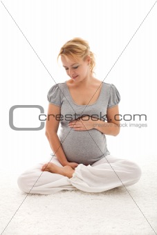 Beautiful pregnant woman thinking of her baby