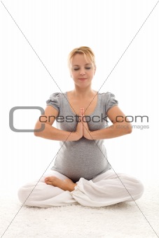 Pregnant woman doing exercises on the floor