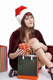 The girl in a Christmas cap with purchases