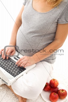 Pregnant woman having some apples - closeup
