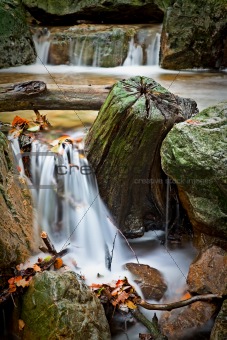 small waterfall in autumn river