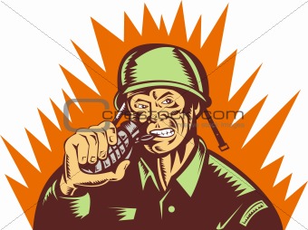Army soldier pulling biting pin of hand grenade