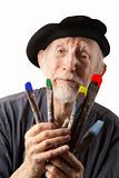 Senior artist with beret and brushes