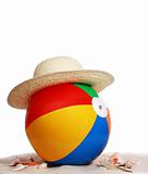 beach ball and hat on beach sand