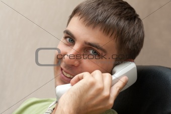 Man with telephone smiles