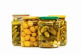 Pickled cucumbers and olives in glass jar